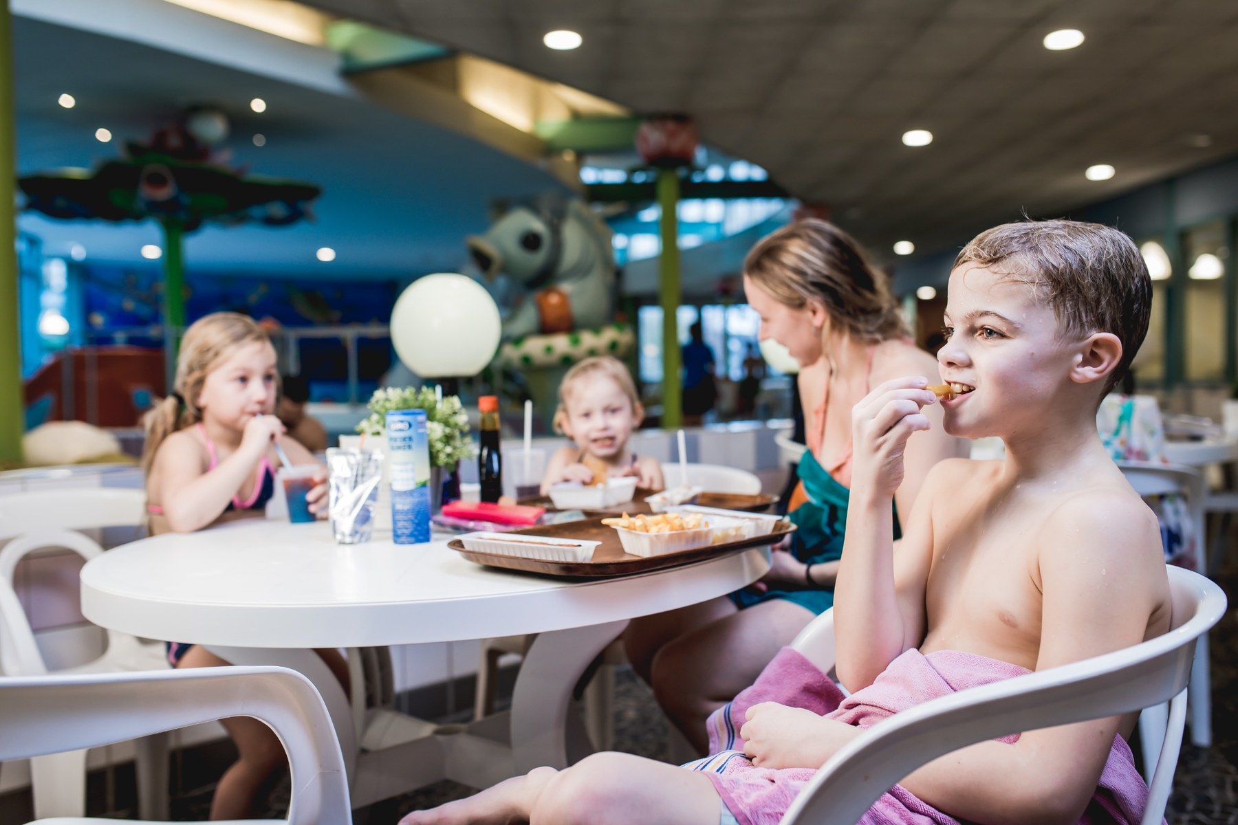 Gezin geniet aan tafel van een hapje bij Tasttoe
